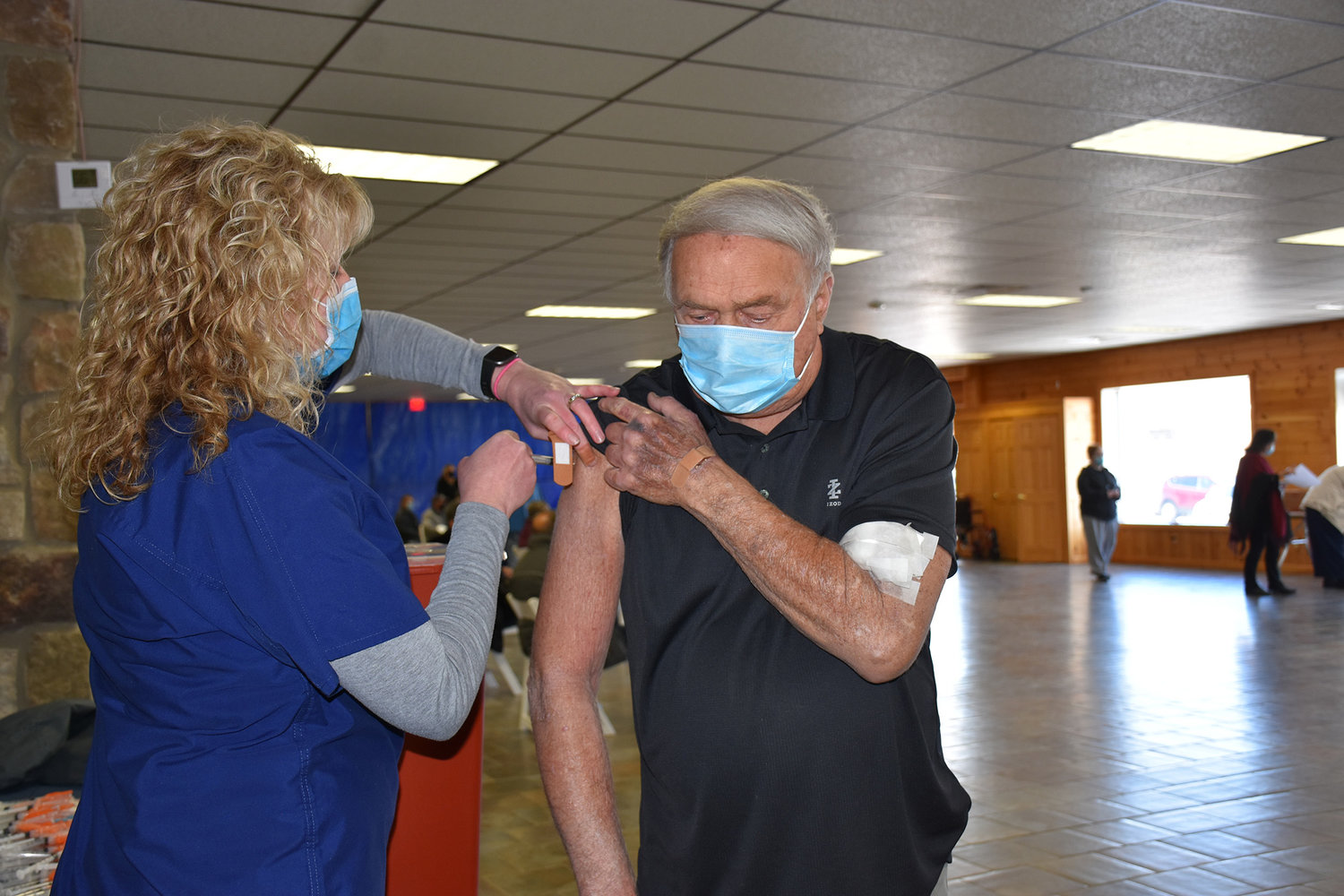 Sarah Mickel, LPN, administers a COVID-19 vaccine to Thomas Bajadek at the former Rusty Palmer’s in Honesdale in March. ..